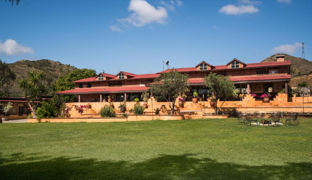 a large building with a lawn in front of it at Horsepower Ranch in Ensenada