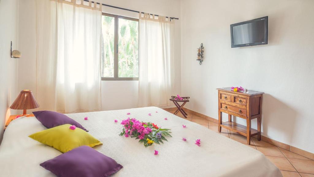 Postel nebo postele na pokoji v ubytování Hotel Laguna del Cocodrilo