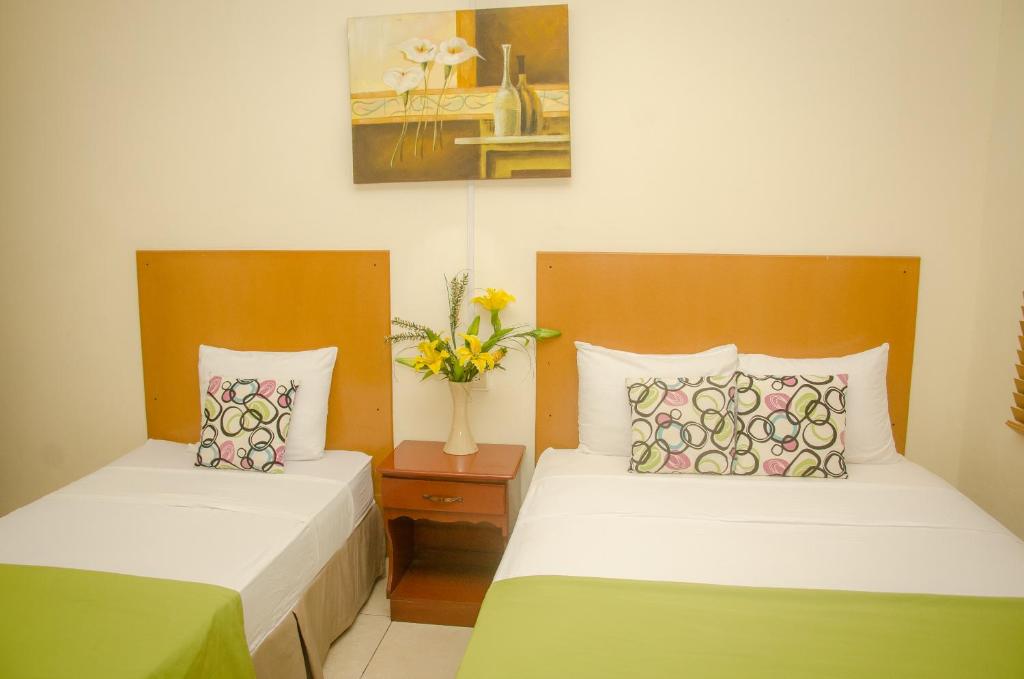 Postel nebo postele na pokoji v ubytování Hotel Residencial Cervantes