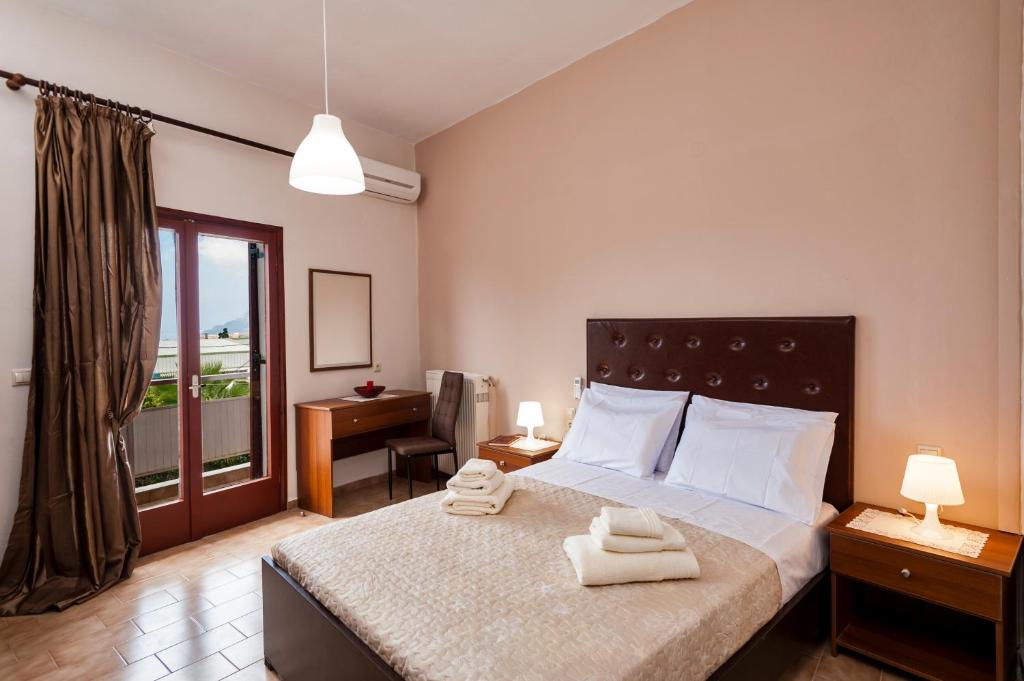 a bedroom with a bed with two towels on it at Falassarna House in Plátanos