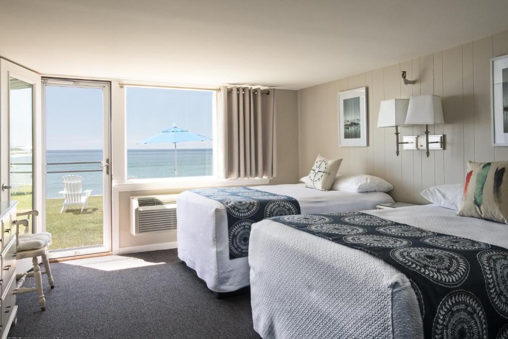 a hotel room with two beds and a view of the ocean at Cutty Sark Motel in York Beach