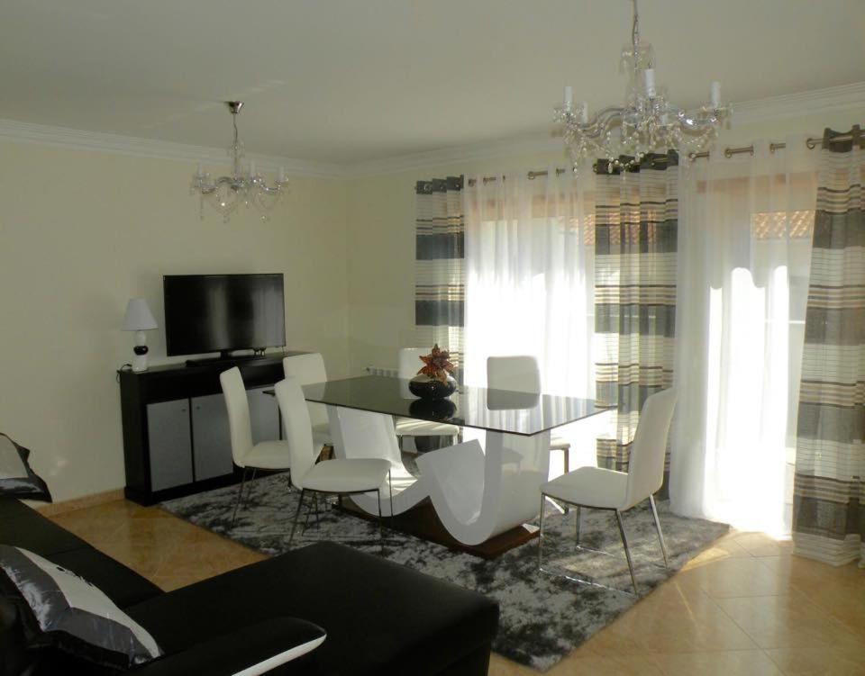 a living room with a dining room table and chairs at AS 3 GAIVOTAS in Vila Praia de Âncora