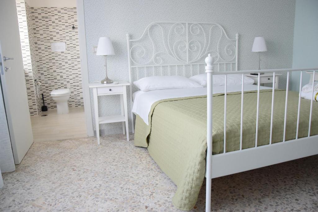 a bedroom with a white bed and a white bed frame at San Lorenzo in Benevento