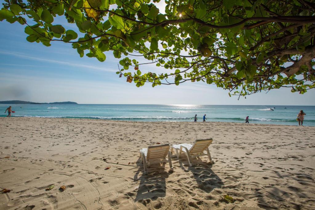 two beach chairs sitting on the sand on the beach at Long Beach Lodge, Chaweng Beach, Koh Samui in Chaweng