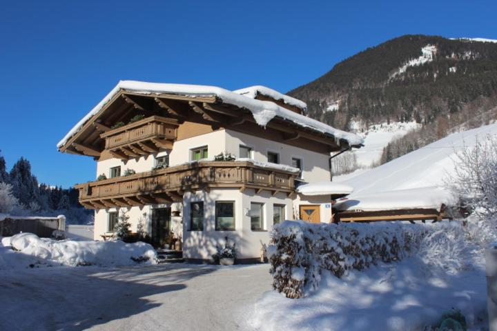 a large building with snow on top of it at Haus Burgi in Maishofen