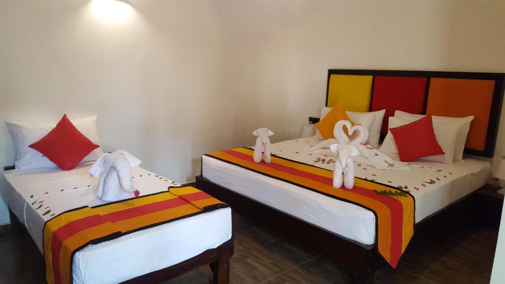 Postel nebo postele na pokoji v ubytování Sigiri Resort