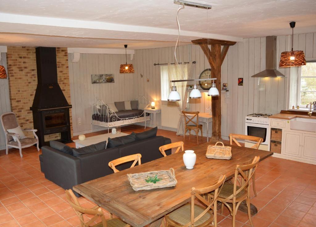 a living room with a table and a couch at Gite De Saba in La Celle-Condé