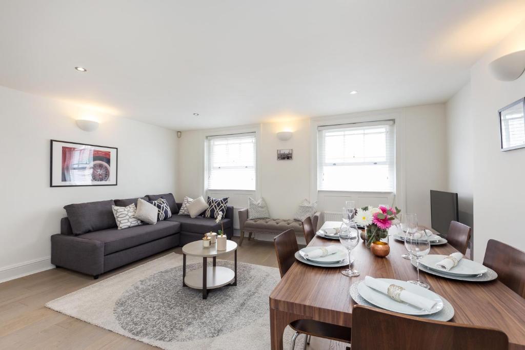 a living room with a table and a couch at Covent Garden Maisonette in London