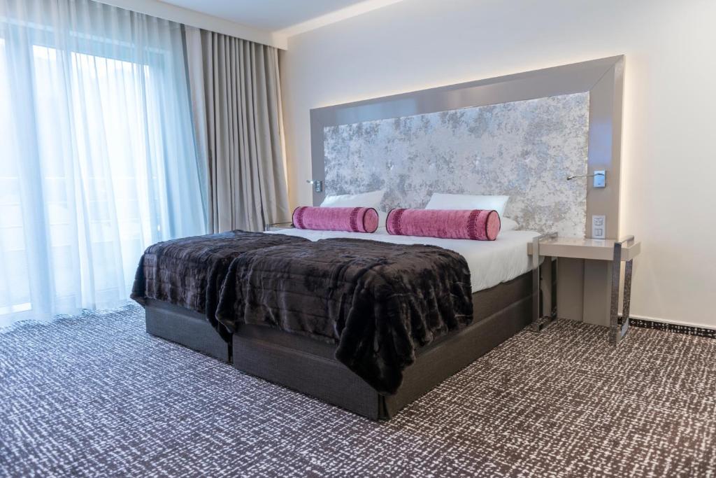 Postel nebo postele na pokoji v ubytování Le Chateau Des Thermes