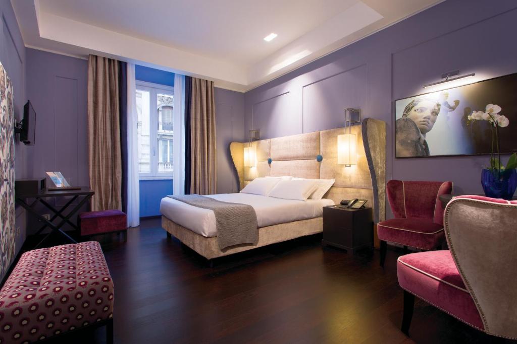 Stendhal Luxury Suites tesisinde bir odada yatak veya yataklar