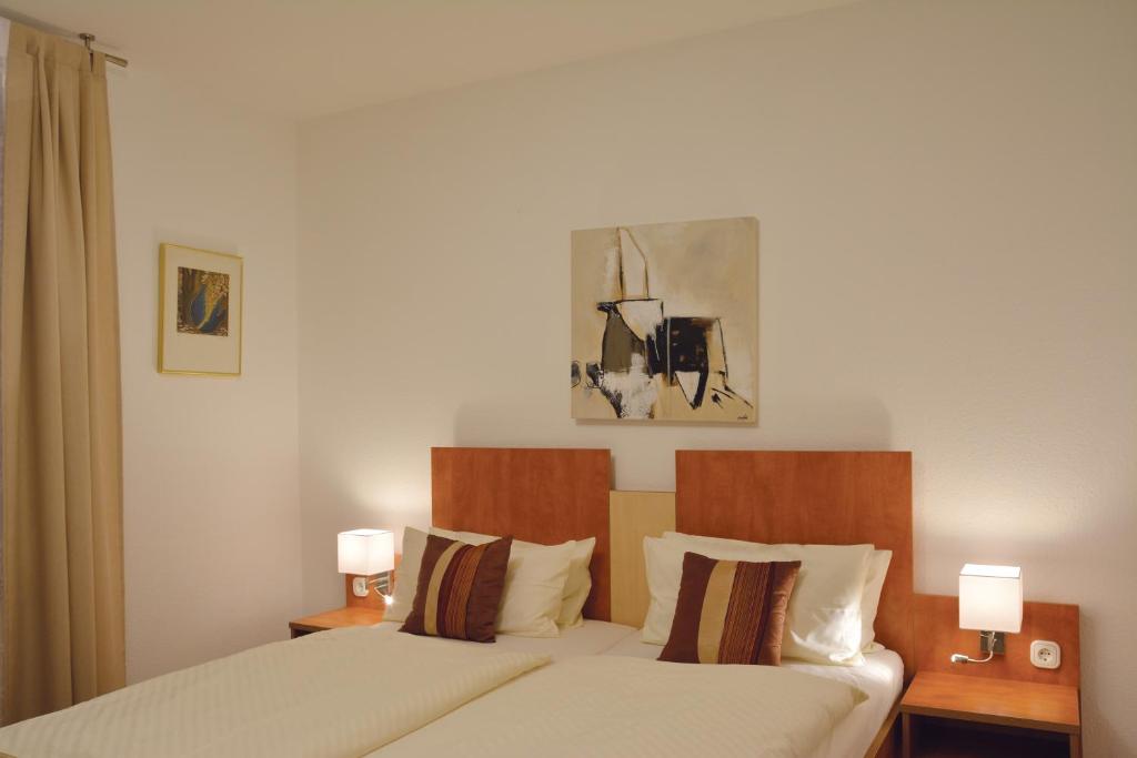 Postel nebo postele na pokoji v ubytování Boutique Hotel Wolfsburg