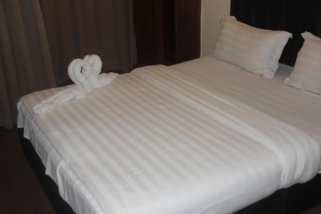 Postel nebo postele na pokoji v ubytování Alonto Hotel