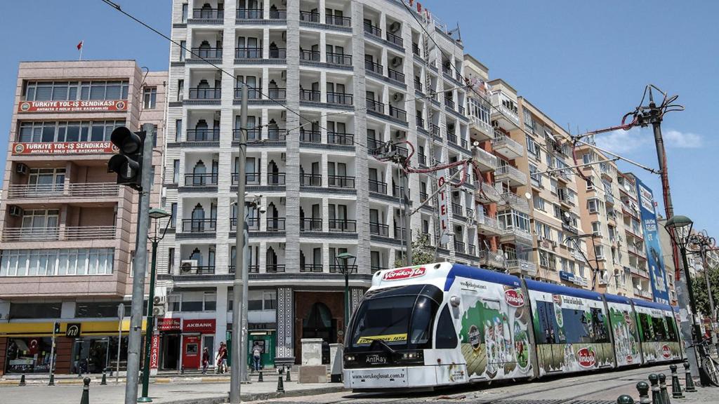 a train on a street in front of a building at Start Hotel in Antalya