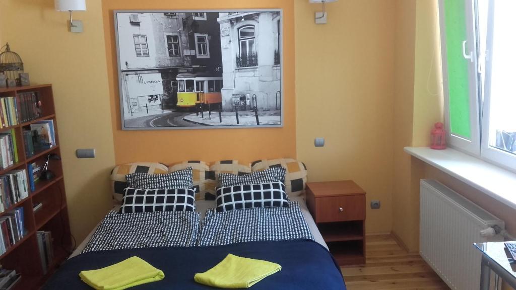a bedroom with a bed and a picture on the wall at Aga House in Gdańsk