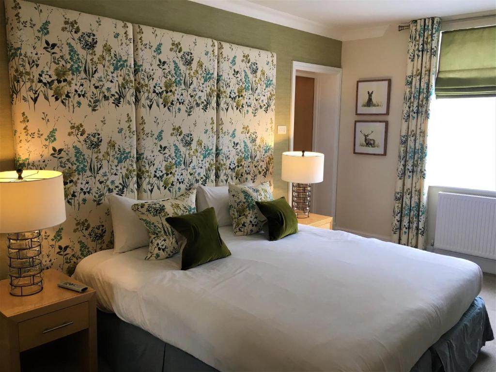A bed or beds in a room at The Highworth Hotel 