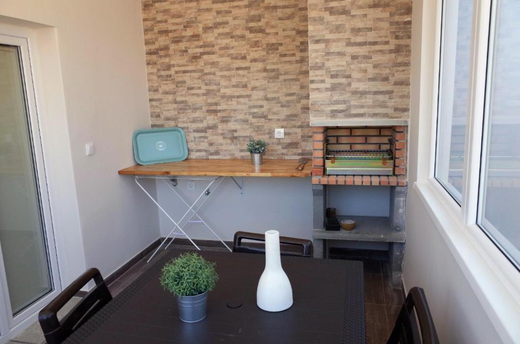 a dining room with a table and a laptop on a wall at Lisbon Beach Apartments 2 in Costa da Caparica