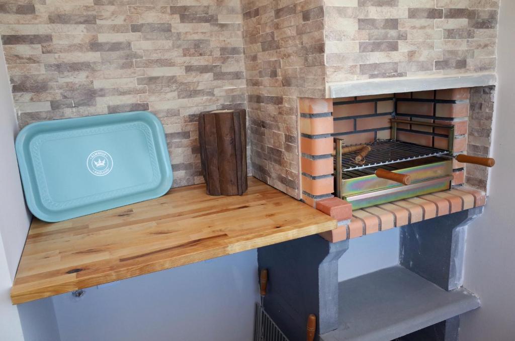 a wooden counter top with a brick fireplace at Lisbon Beach Apartments 4 in Costa da Caparica
