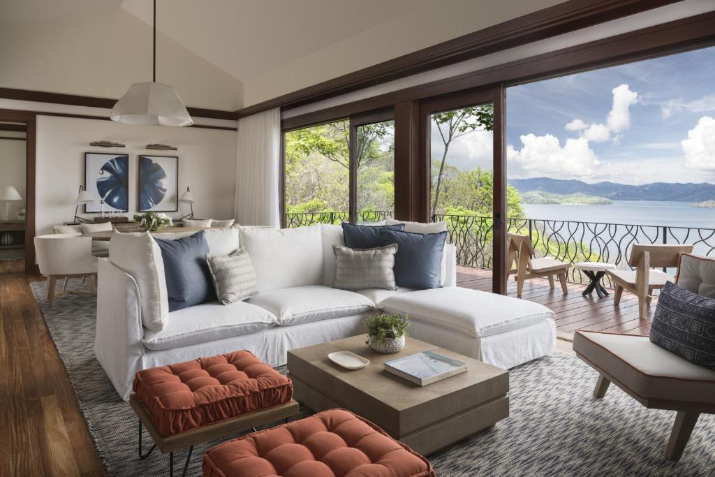 a living room with a white couch and large windows at Four Seasons Resort Costa Rica at Peninsula Papagayo in Culebra