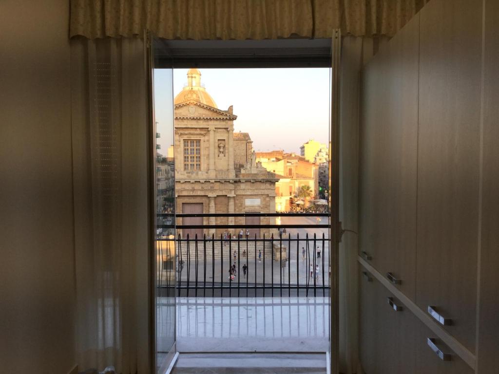 a view of a building from an open window at Affittacamere Duomo in Gela