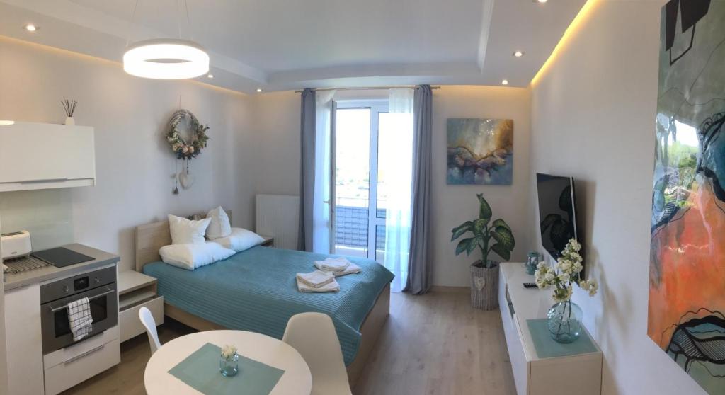 Televízia a/alebo spoločenská miestnosť v ubytovaní Apartament No.1