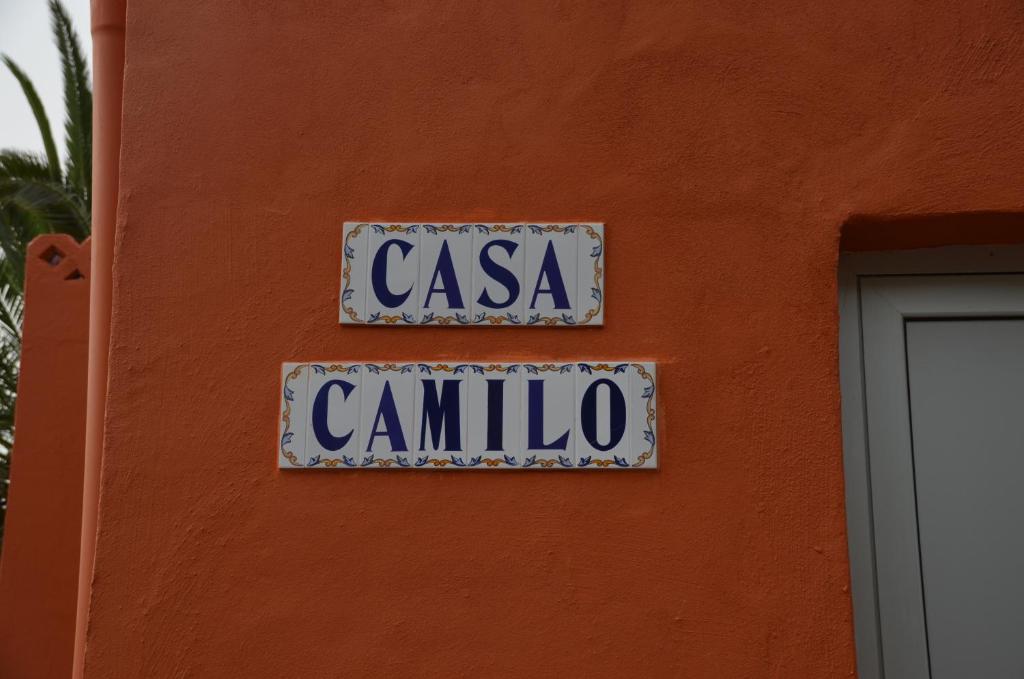 a street sign on the side of a orange wall at Casa Camilo in Vallehermoso