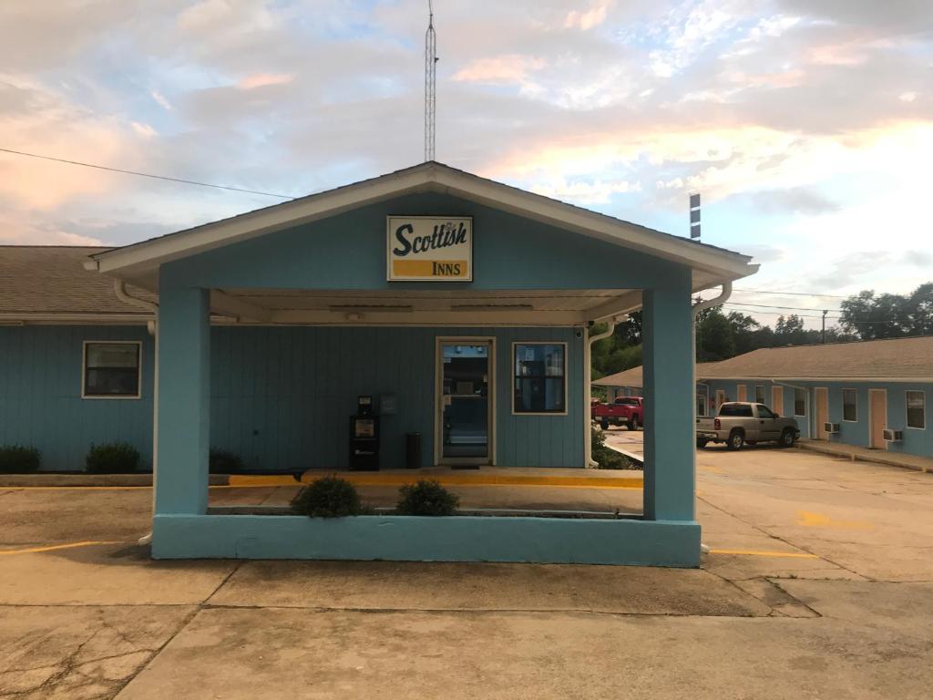 a small blue building with a sign on it at Scottish Inn - Clanton in Clanton