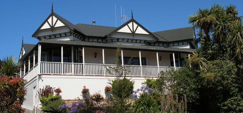 een groot wit huis met een zwart dak bij Nelson Heights Bed & Breakfast in Timaru