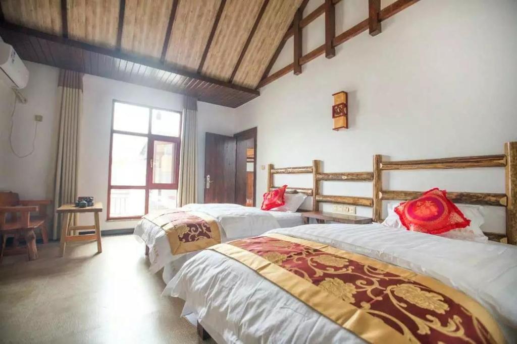 Postel nebo postele na pokoji v ubytování Tian Jia Xiao Yuan Boutique Homestay
