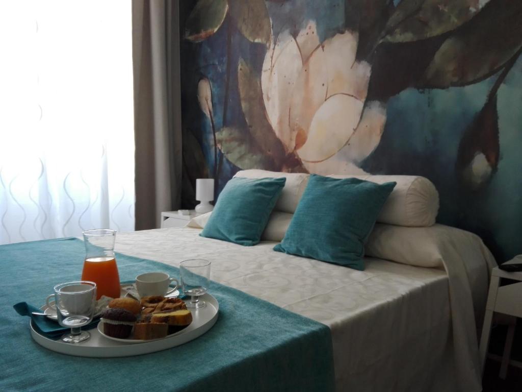 a bedroom with a bed with a plate of food on it at Domus Crescenzio - Guest House in Rome