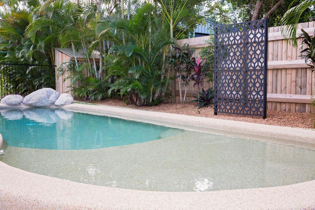 a swimming pool in a yard with a fence at 7 McNamara - Wongaling Beach in Mission Beach