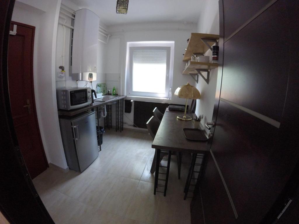 a small kitchen with a table and a microwave at Dózsaház in Zalaegerszeg