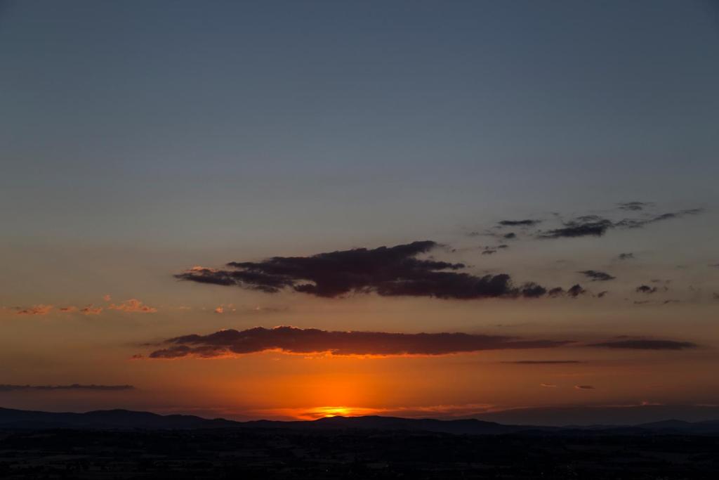 The sunrise or sunset as seen from the country house or nearby