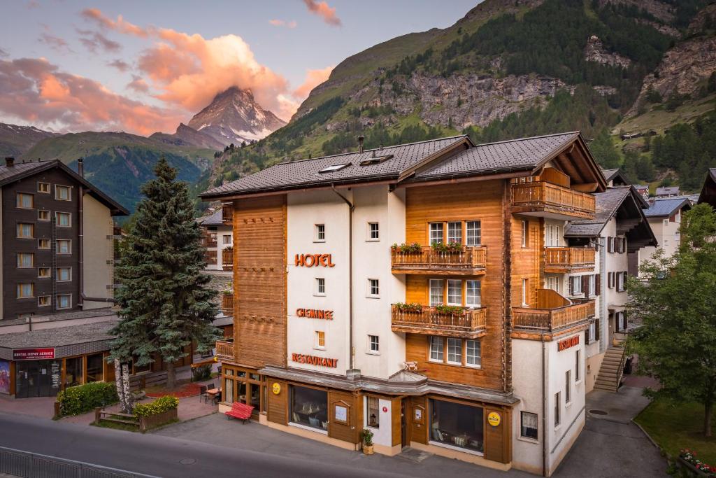 a hotel in the mountains with a mountain at Hotel Cheminee in Zermatt