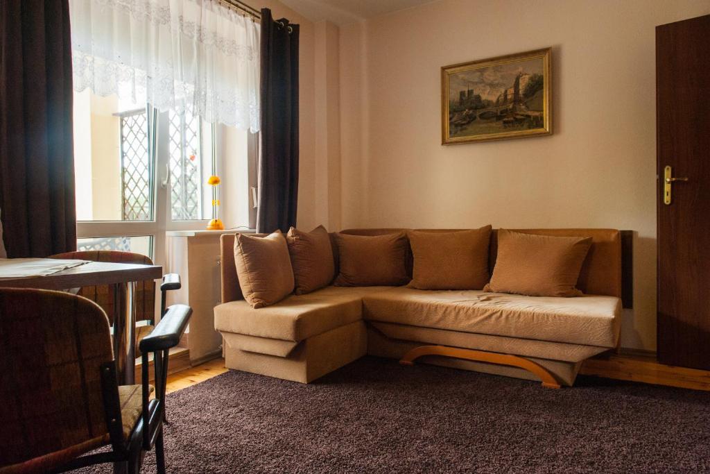 a living room with a couch and a window at Villa Ambra in Osowa