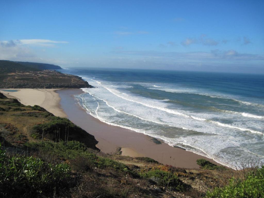 an aerial view of a beach with the ocean at Ericeira Surf and Sun in Ericeira