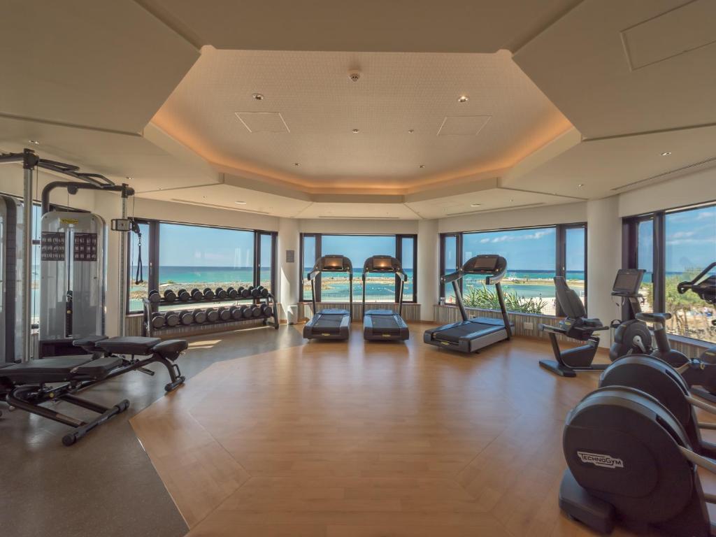 a gym with treadmills and exercise equipment in a building at Sheraton Okinawa Sunmarina Resort in Onna