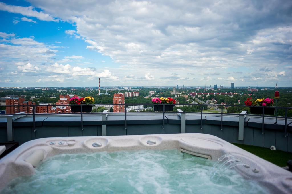 a hot tub on the roof of a building at Skyhouse Riga Amazing Penthouse and SPA in Rīga