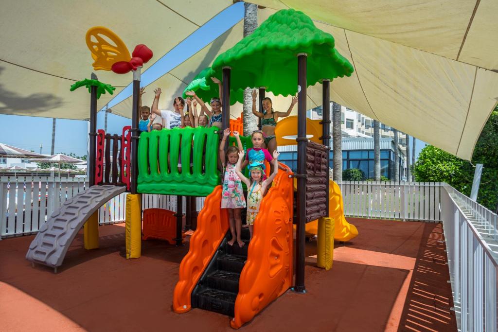a group of children playing on a playground at Pavlo Napa Beach Hotel in Ayia Napa