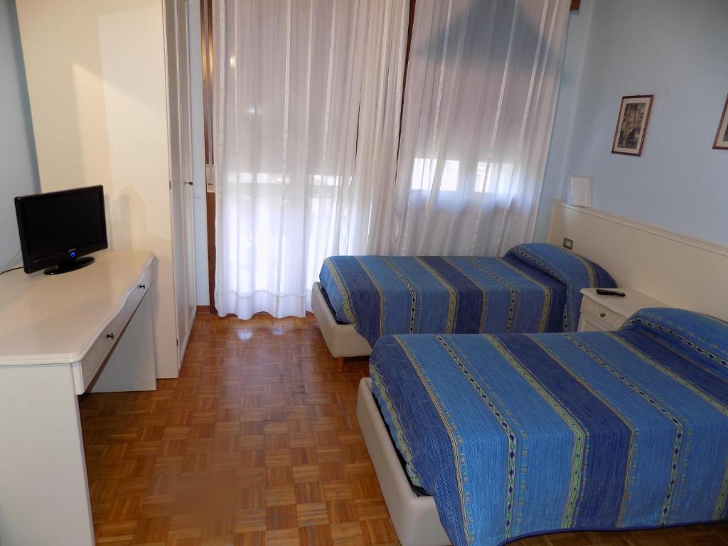 Postel nebo postele na pokoji v ubytování Hotel Udinese da Aldo