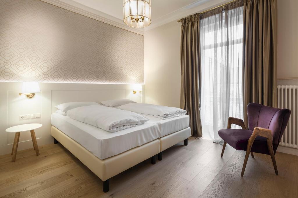 Łóżko lub łóżka w pokoju w obiekcie Hotel Europa Splendid