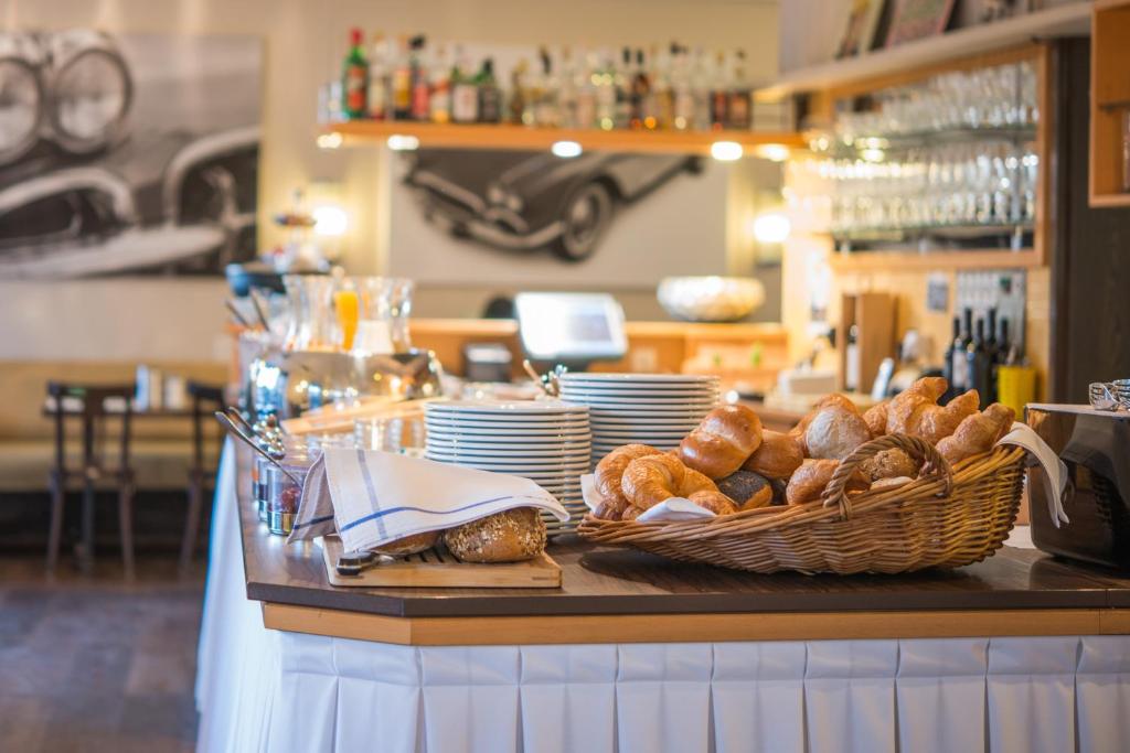 a table with a basket of bread on a counter at Hotel Neufeld in Zürich