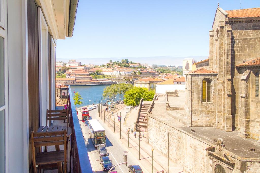 a balcony of a building with a view of a street at Liiiving in Porto | Ribeira Boutique Apartment in Porto