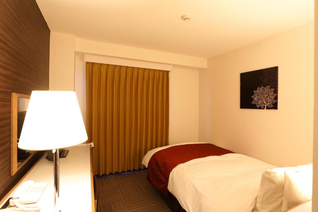 Postel nebo postele na pokoji v ubytování Hotel Leon Hamamatsu