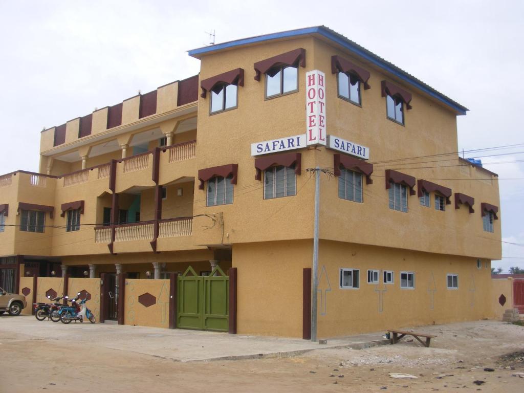 a building with a sign on the side of it at Hotel Safari COTONOU in Cotonou