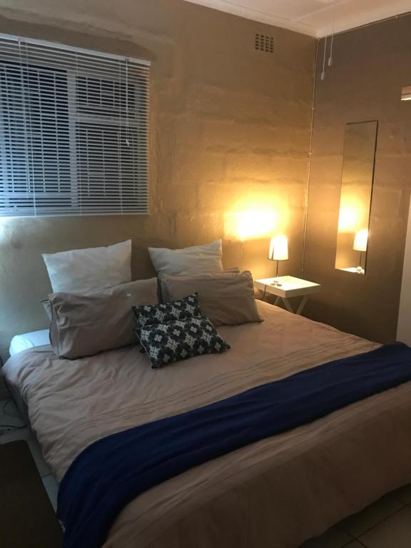 a bedroom with a large bed with two pillows on it at Ian and Pam's Flatlet in Empangeni