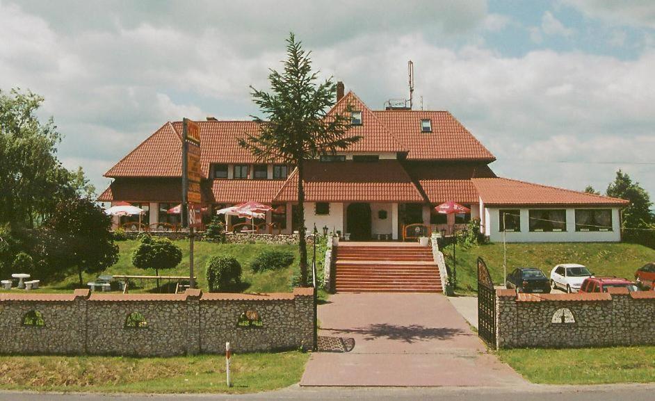 a large house with a fence in front of it at Zajazd Kosynier in Węgrzce