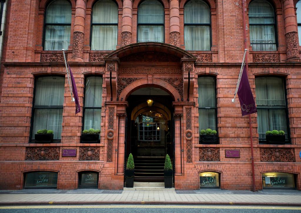 a red brick building with a revolving door at Quebecs in Leeds