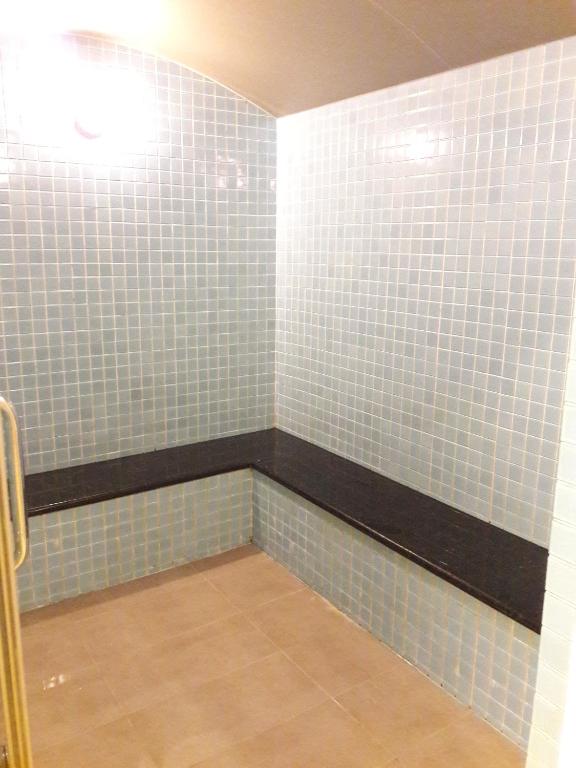 a bathroom with blue tiles on the walls at Bluesky Serviced Apartment Airport Plaza in Ho Chi Minh City