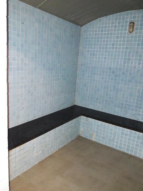 a corner of a room with blue tiled walls at Bluesky Serviced Apartment Airport Plaza in Ho Chi Minh City