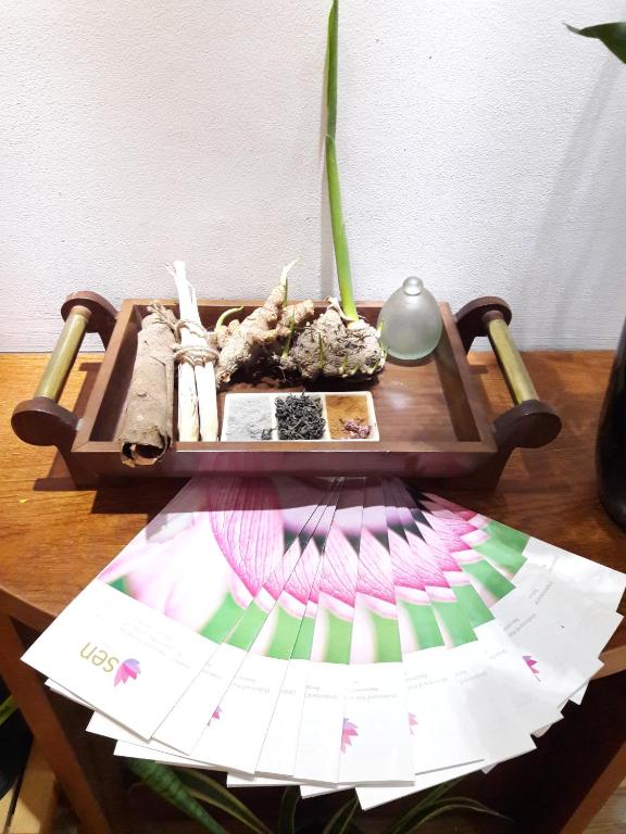 a wooden table with a paper on a table at Bluesky Serviced Apartment Airport Plaza in Ho Chi Minh City